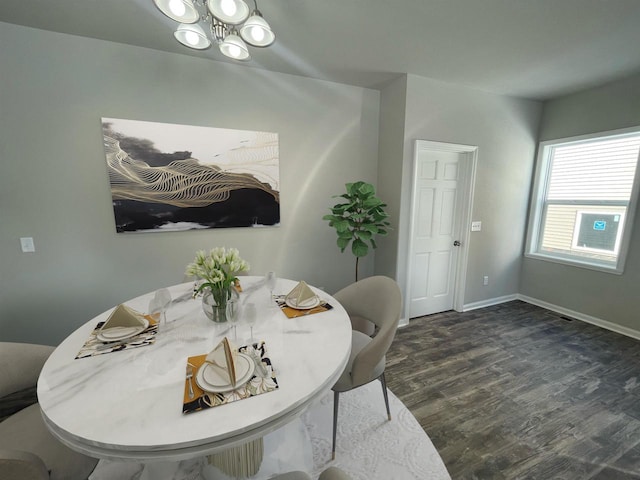 720 E Maple Beach Dr, Edgerton, WI 53534 - dining room featuring a chandelier, dark wood-style flooring, and baseboards