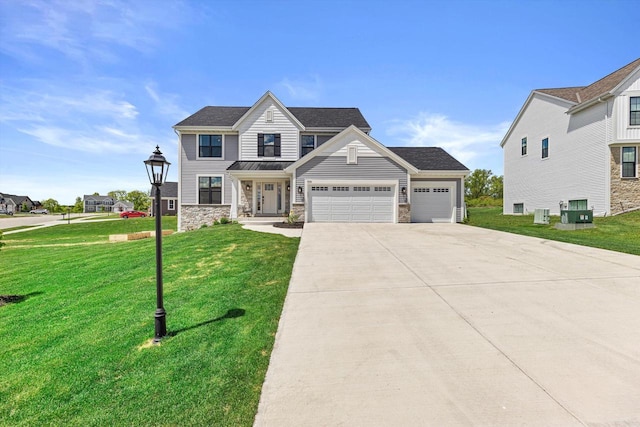 3741 Howell Oaks Dr, Waukesha, WI 53188 - view of front facade with an attached garage, driveway, a front lawn, and stone siding