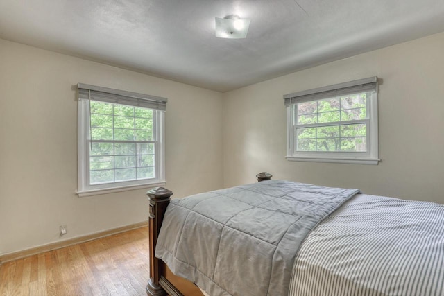13460 Tremont St, Brookfield, WI 53005 - bedroom with multiple windows, wood finished floors, and baseboards