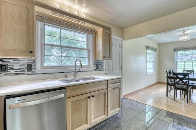 13460 Tremont St, Brookfield, WI 53005 - kitchen with stainless steel dishwasher, a sink, tasteful backsplash, baseboards, and light brown cabinets