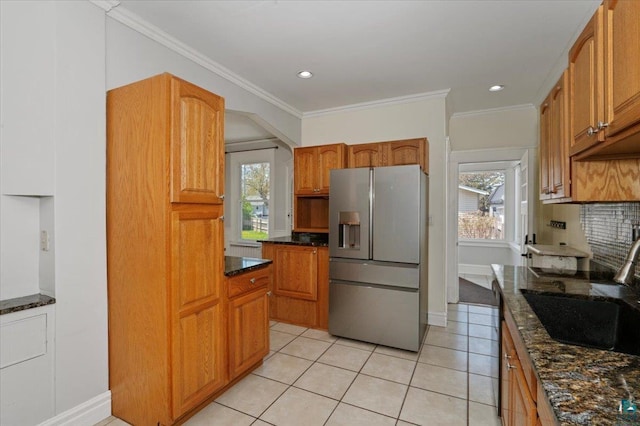 2127 Tower Ave, Superior, WI 54880 - kitchen featuring stainless steel fridge, a sink, dark stone countertops, healthy amount of natural light, and crown molding
