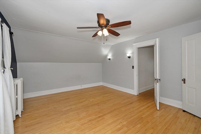 2127 Tower Ave, Superior, WI 54880 - additional living space with radiator heating unit, a ceiling fan, light wood-type flooring, lofted ceiling, and baseboards