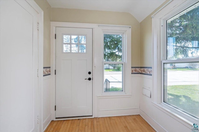 2127 Tower Ave, Superior, WI 54880 - foyer entrance featuring a wainscoted wall, plenty of natural light, light wood-style floors, lofted ceiling, and a decorative wall