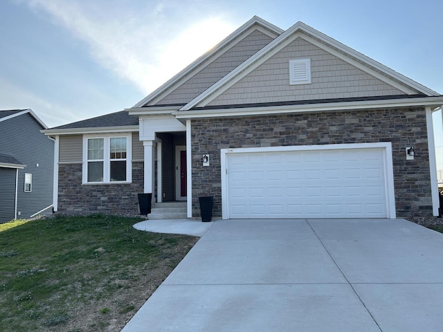 704 River Ridge Drive, Waterford, WI 53185 - craftsman-style house with concrete driveway, a front yard, stone siding, and a garage
