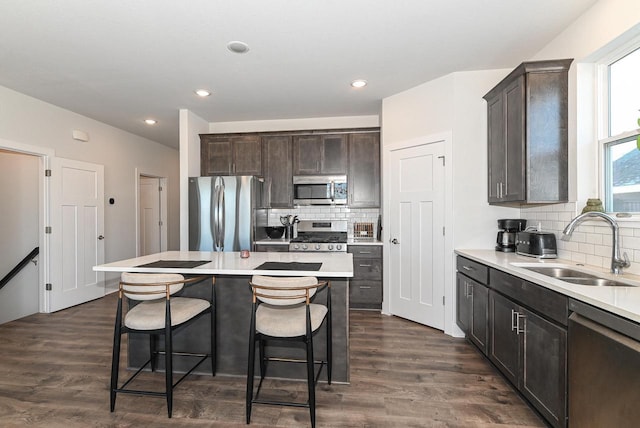 704 River Ridge Drive, Waterford, WI 53185 - kitchen featuring stainless steel appliances, a sink, backsplash, dark brown cabinets, and recessed lighting