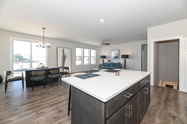 704 River Ridge Drive, Waterford, WI 53185 - kitchen with dark wood finished floors, light countertops, a chandelier, a center island, and recessed lighting