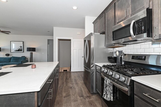 704 River Ridge Drive, Waterford, WI 53185 - kitchen with stainless steel appliances, open floor plan, dark wood finished floors, backsplash, and light countertops