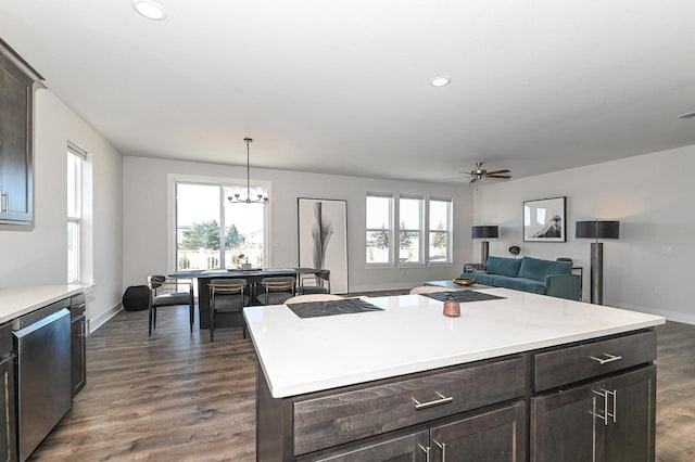 704 River Ridge Drive, Waterford, WI 53185 - kitchen with stainless steel dishwasher, dark brown cabinets, a chandelier, light countertops, and recessed lighting