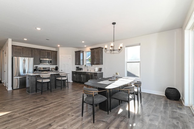 704 River Ridge Drive, Waterford, WI 53185 - dining room with a chandelier, dark wood finished floors, baseboards, and recessed lighting