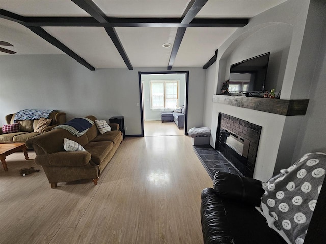 419 N 3rd Ave, Wausau, WI 54401 - living room featuring a glass covered fireplace, wood finished floors, beam ceiling, baseboards, and ceiling fan