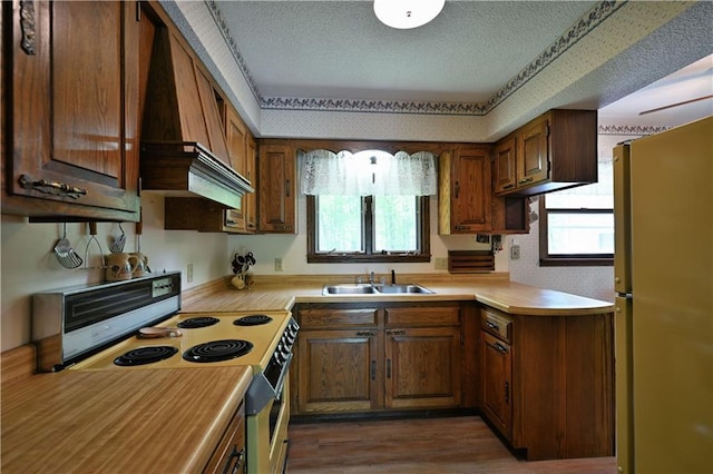 W2847 County Highway B, Sarona, WI 54870 - kitchen with freestanding refrigerator, range with electric cooktop, a sink, a textured ceiling, and light countertops