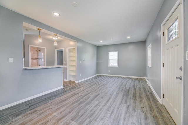 4935 N 56th St, Milwaukee, WI 53218 - unfurnished living room with wood finished floors, baseboards, and recessed lighting