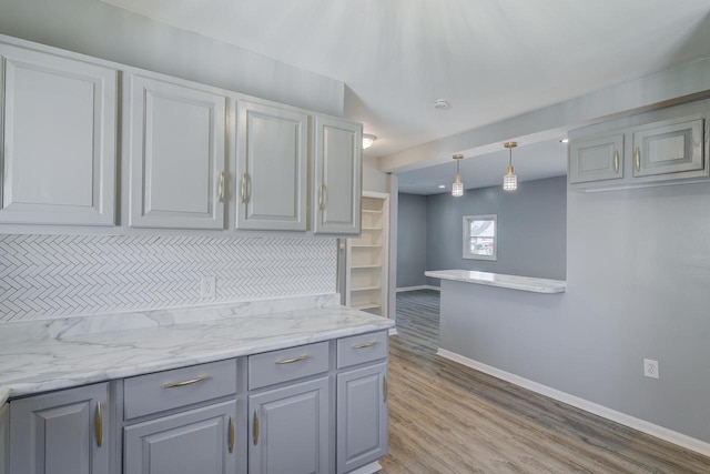 4935 N 56th St, Milwaukee, WI 53218 - kitchen featuring gray cabinetry, baseboards, light wood-type flooring, and hanging light fixtures