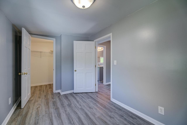 4935 N 56th St, Milwaukee, WI 53218 - unfurnished bedroom featuring wood finished floors, baseboards, a spacious closet, and a closet