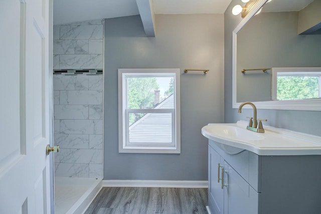 4935 N 56th St, Milwaukee, WI 53218 - bathroom featuring vanity, a tile shower, wood finished floors, and baseboards