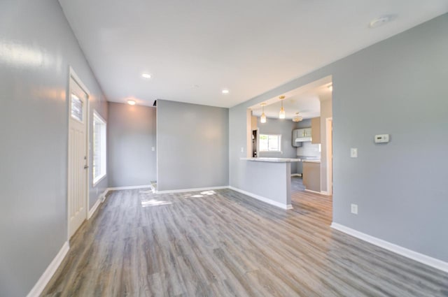 4935 N 56th St, Milwaukee, WI 53218 - unfurnished living room featuring baseboards, wood finished floors, and recessed lighting