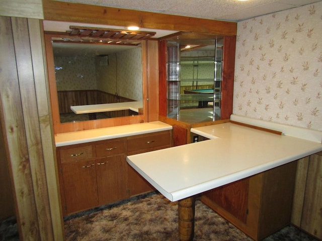 2374 S Park Ave, Beloit, WI 53511 - kitchen featuring wallpapered walls, brown cabinets, light countertops, and a peninsula