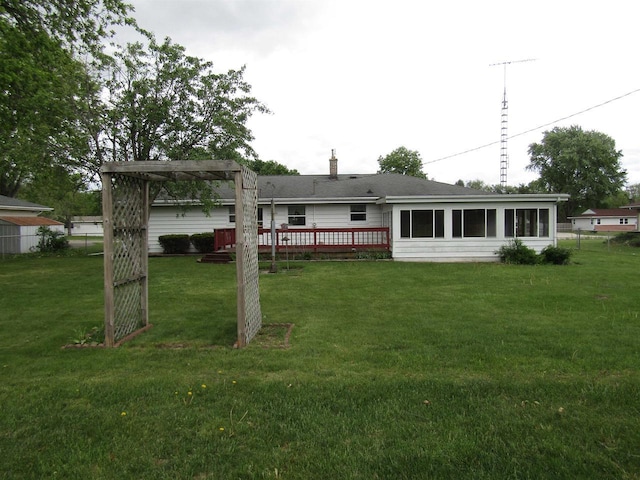 2374 S Park Ave, Beloit, WI 53511 - back of house with a yard, a wooden deck, and a chimney