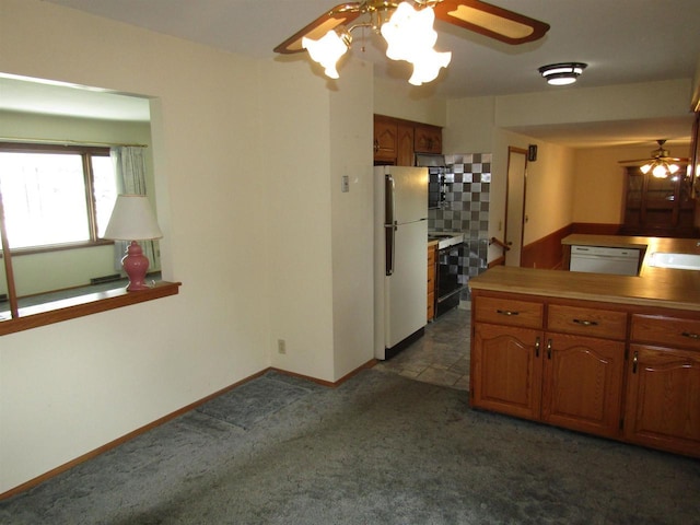 2374 S Park Ave, Beloit, WI 53511 - kitchen featuring white appliances, a ceiling fan, dark colored carpet, and a sink