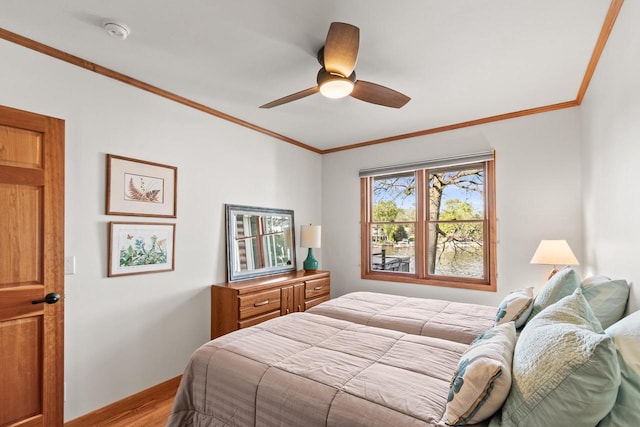 491 River St, Merrimac, WI 53561 - bedroom with wood finished floors, crown molding, ceiling fan, and baseboards
