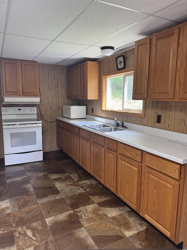 7280 Closing Dam Rd, Cassville, WI 53806 - kitchen with white appliances, a sink, wooden walls, a paneled ceiling, and under cabinet range hood