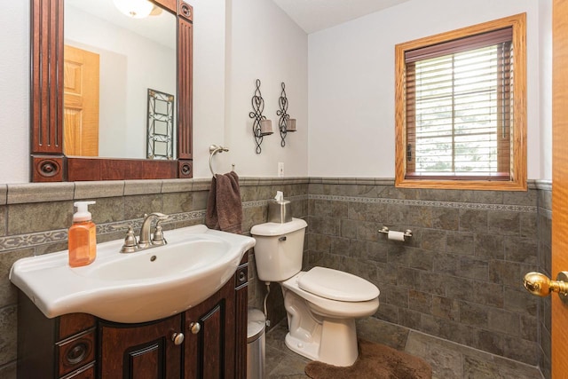 800 Ridge Ave, Platteville, WI 53818 - half bath featuring tile walls, vanity, toilet, a wainscoted wall, and tile patterned floors