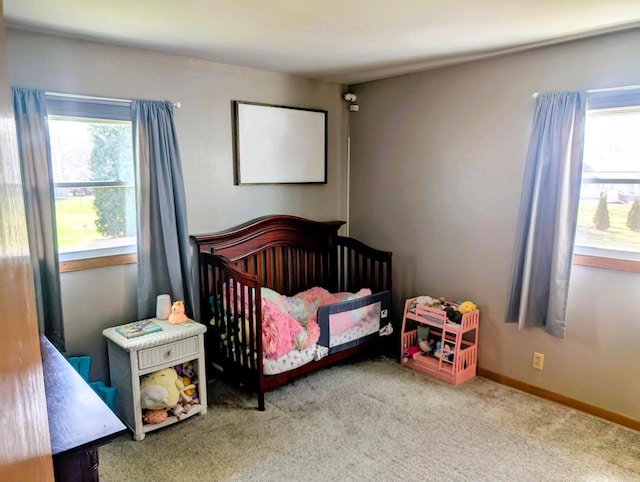 3434 Kentucky St, Racine, WI 53405 - carpeted bedroom featuring multiple windows, a nursery area, and baseboards