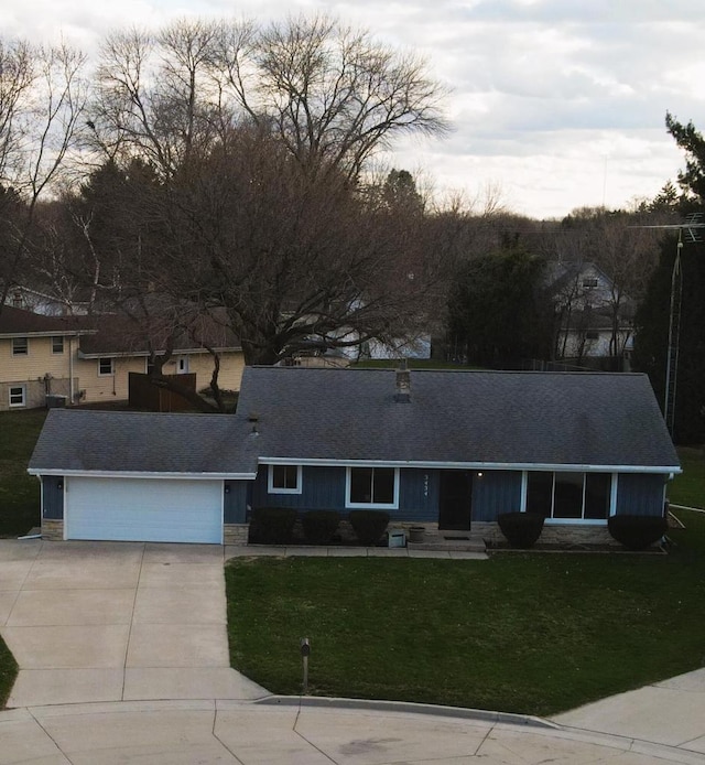 3434 Kentucky St, Racine, WI 53405 - view of front facade featuring driveway, a garage, stone siding, a front lawn, and a shingled roof