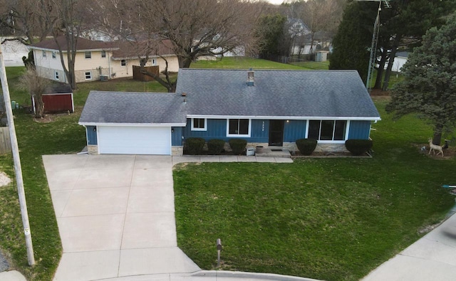 3434 Kentucky St, Racine, WI 53405 - view of front facade featuring stone siding, a shingled roof, concrete driveway, an attached garage, and a front lawn