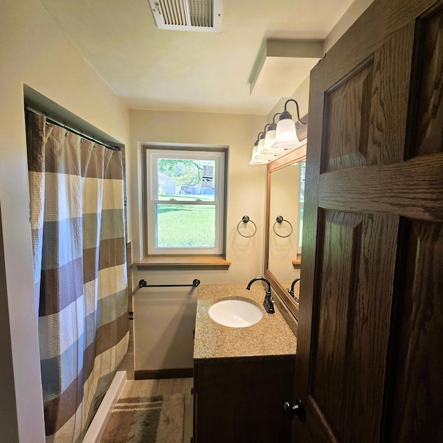 3434 Kentucky St, Racine, WI 53405 - bathroom with vanity and wood finished floors