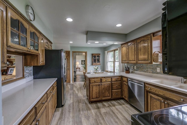 4034 Chicory Rd, Mount Pleasant, WI 53403 - kitchen featuring appliances with stainless steel finishes, light wood-style floors, tasteful backsplash, a peninsula, and recessed lighting
