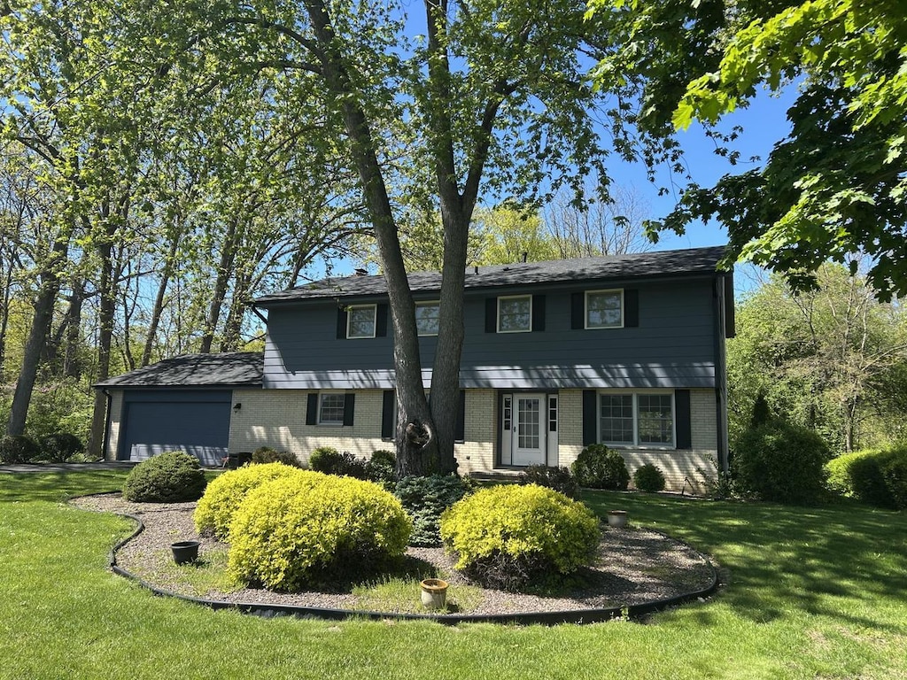 4034 Chicory Rd, Mount Pleasant, WI 53403 - colonial inspired home featuring brick siding, a front lawn, and an attached garage