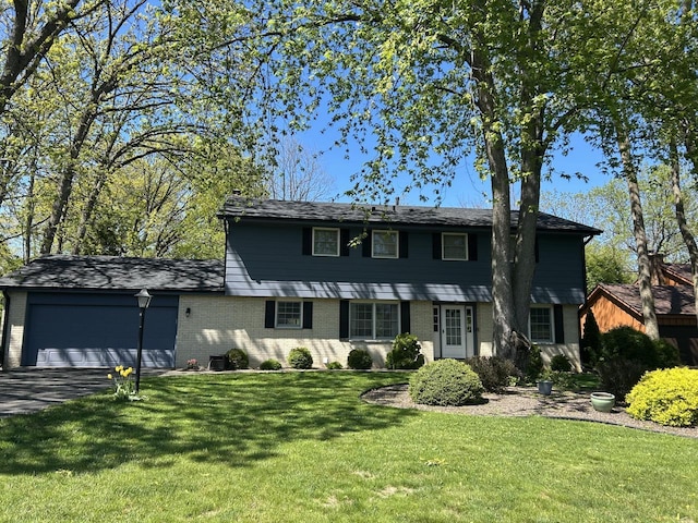 4034 Chicory Rd, Mount Pleasant, WI 53403 - colonial home with an attached garage, brick siding, asphalt driveway, and a front lawn