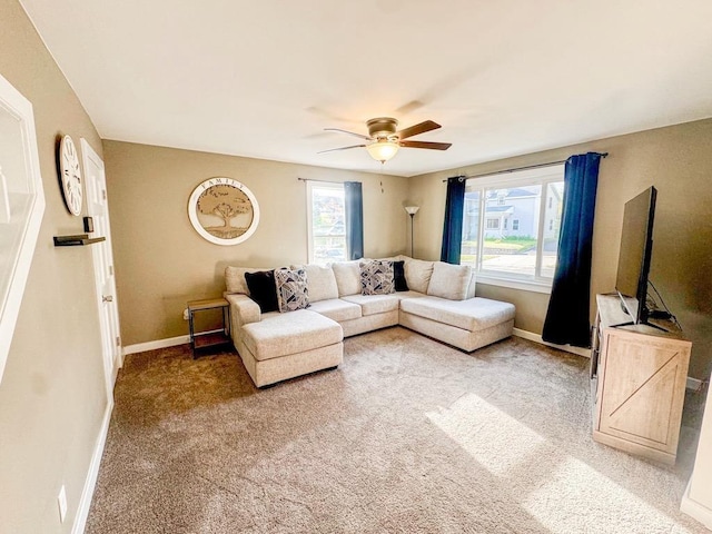 509 E Jefferson St, Stoughton, WI 53589 - living area with baseboards, a ceiling fan, and light carpet