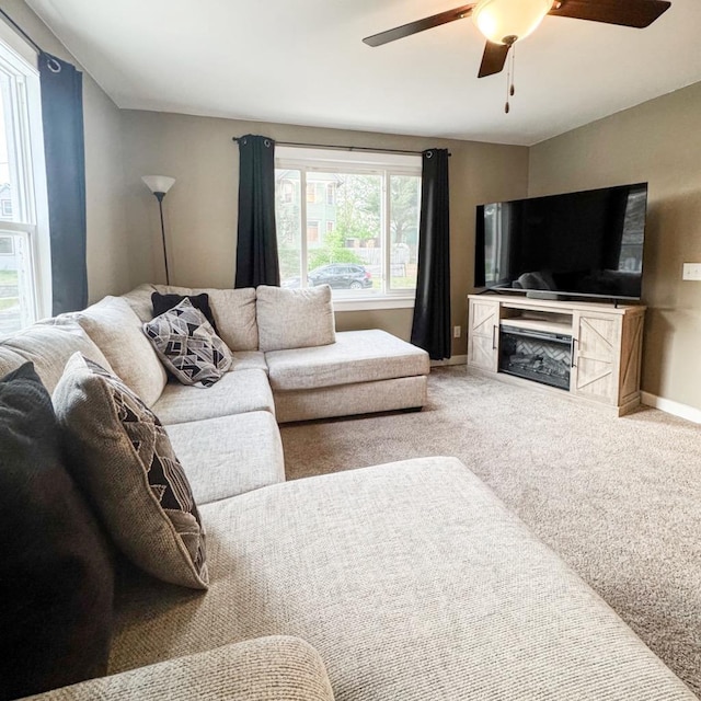 509 E Jefferson St, Stoughton, WI 53589 - living area featuring ceiling fan, carpet floors, baseboards, and a fireplace