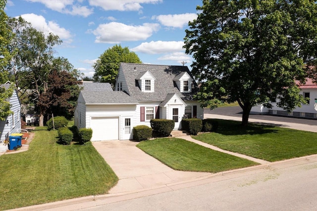 403 N Rock Ave, Viroqua, WI 54665 - cape cod-style house featuring a garage, driveway, a front lawn, and a shingled roof
