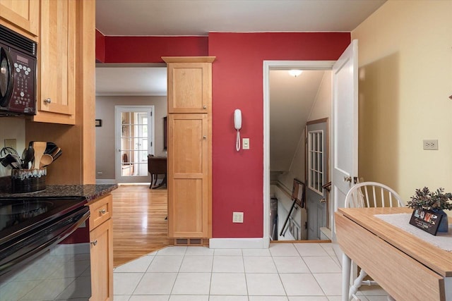 403 N Rock Ave, Viroqua, WI 54665 - kitchen with black appliances, light brown cabinets, light tile patterned floors, and baseboards