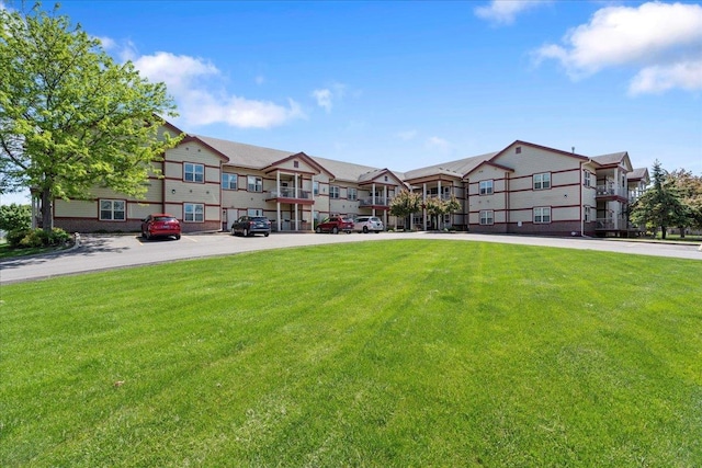 1300 School St Unit 209, Sun Prairie, WI 53590 - view of property featuring uncovered parking and a residential view