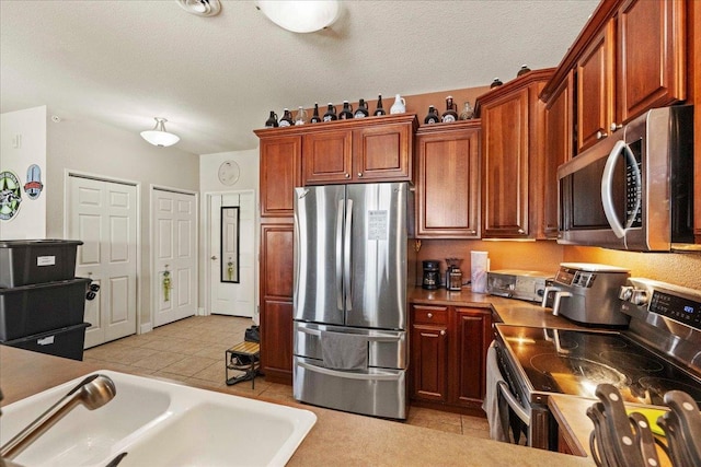 1300 School St Unit 209, Sun Prairie, WI 53590 - kitchen with appliances with stainless steel finishes, a sink, and light tile patterned flooring