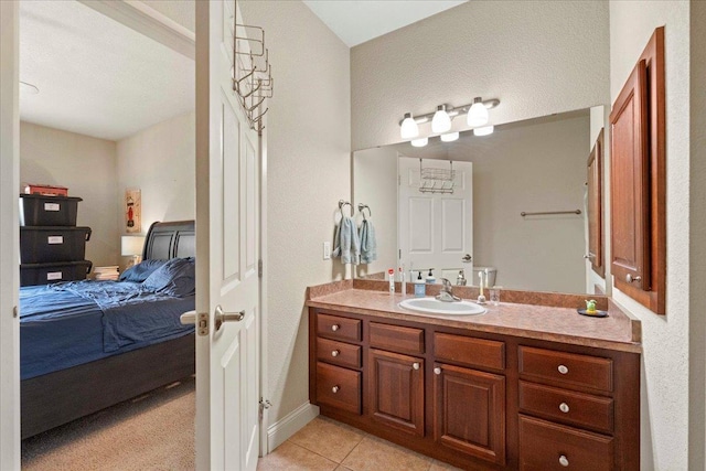 1300 School St Unit 209, Sun Prairie, WI 53590 - ensuite bathroom with vanity, tile patterned floors, and baseboards