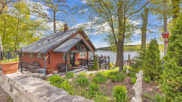 N3665 State Road 67, Campbellsport, WI 53010 - rustic home with a deck with water view, metal roof, and a chimney