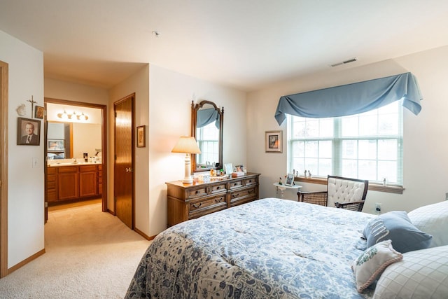 18625 Emerald Cir Unit A, Brookfield, WI 53045 - bedroom featuring light colored carpet, baseboards, and ensuite bath