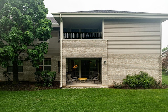 18625 Emerald Cir Unit A, Brookfield, WI 53045 - rear view of property featuring a balcony, brick siding, a lawn, a patio, and roof with shingles
