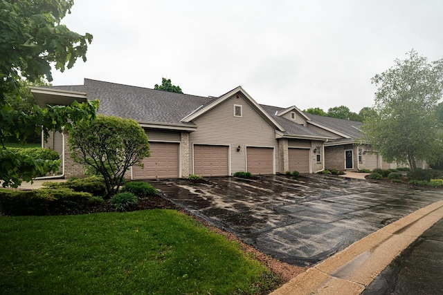 18625 Emerald Cir Unit A, Brookfield, WI 53045 - view of front facade featuring driveway, brick siding, a front yard, a shingled roof, and a garage