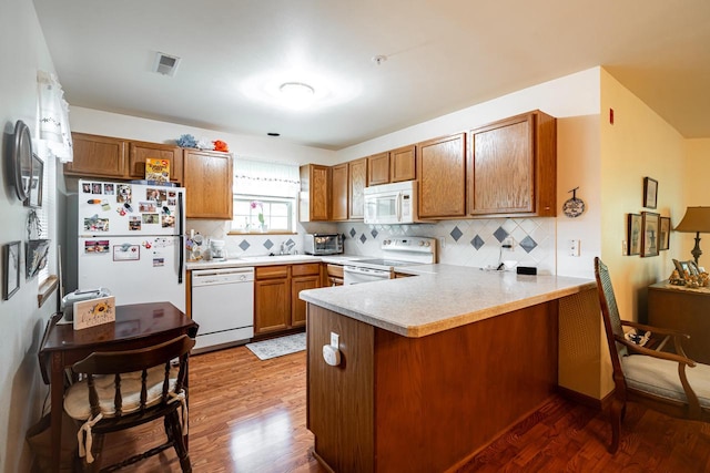18625 Emerald Cir Unit A, Brookfield, WI 53045 - kitchen featuring white appliances, a peninsula, wood finished floors, and brown cabinets