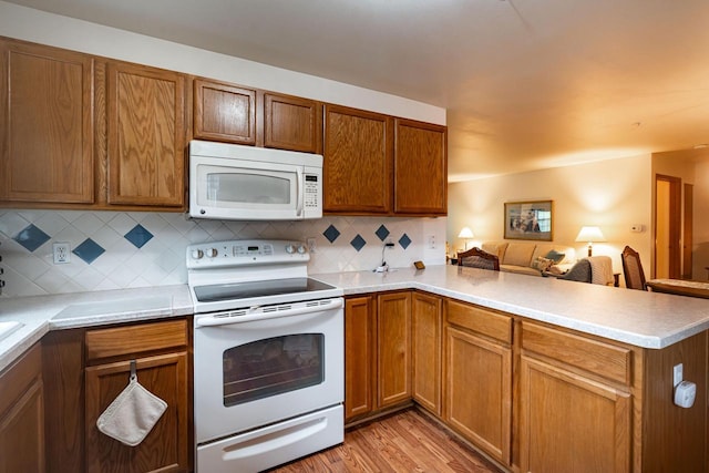 18625 Emerald Cir Unit A, Brookfield, WI 53045 - kitchen featuring white appliances, a peninsula, open floor plan, backsplash, and light countertops