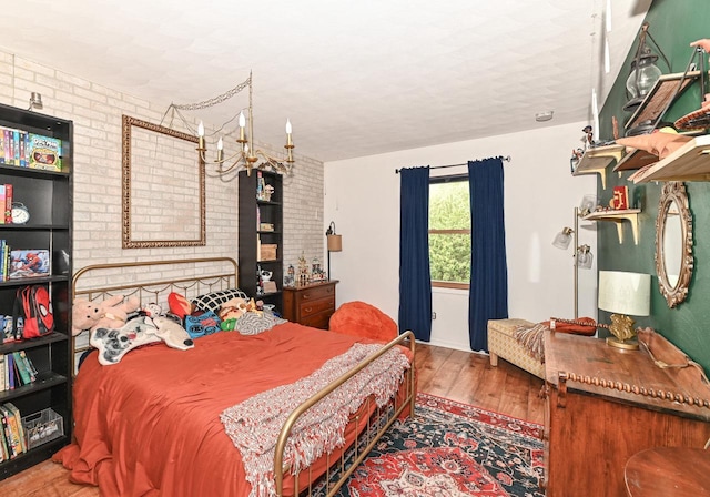 1081 E Elm Rd, Oak Creek, WI 53154 - bedroom with wood finished floors and brick wall