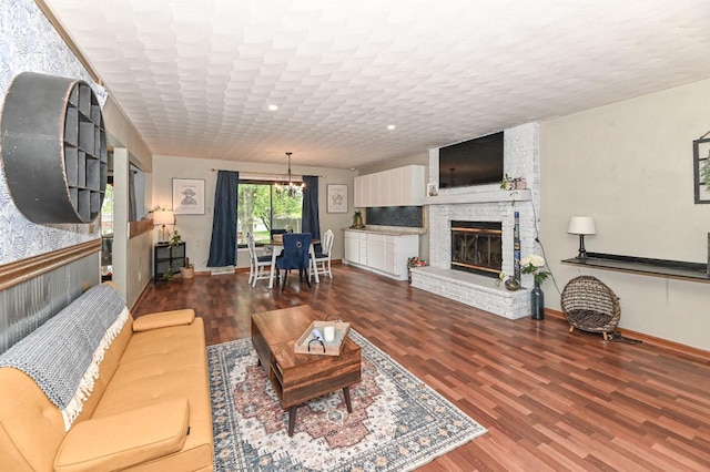 1081 E Elm Rd, Oak Creek, WI 53154 - living area with a chandelier, wood finished floors, baseboards, a brick fireplace, and recessed lighting