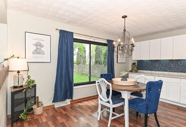 1081 E Elm Rd, Oak Creek, WI 53154 - dining space featuring a chandelier, dark wood finished floors, and baseboards