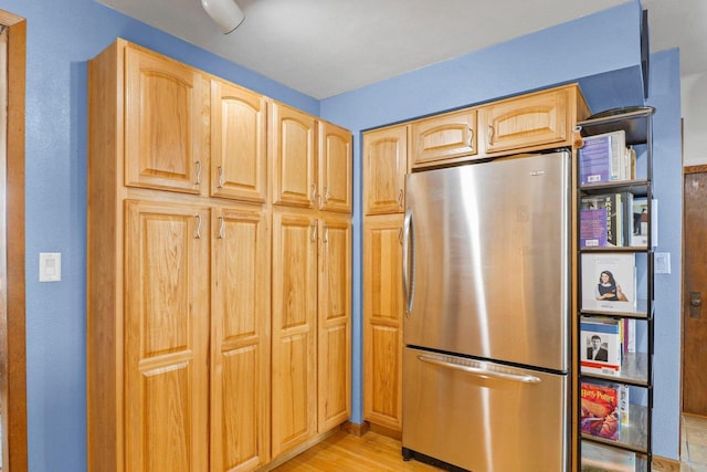 202 Lake St, Mount Horeb, WI 53572 - kitchen with freestanding refrigerator, light wood finished floors, and light brown cabinetry